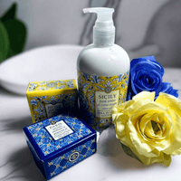 Thumbnail for Elegant bath and body products featuring the Sicily Collection from Essentialgifting.com. The image showcases a bottle of lotion, a decorative box, and vibrant yellow and blue flowers, creating a luxurious, Mediterranean-inspired display.