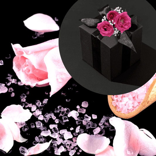 Elegant self-care gift box adorned with vibrant pink roses and crystalline bath salts.