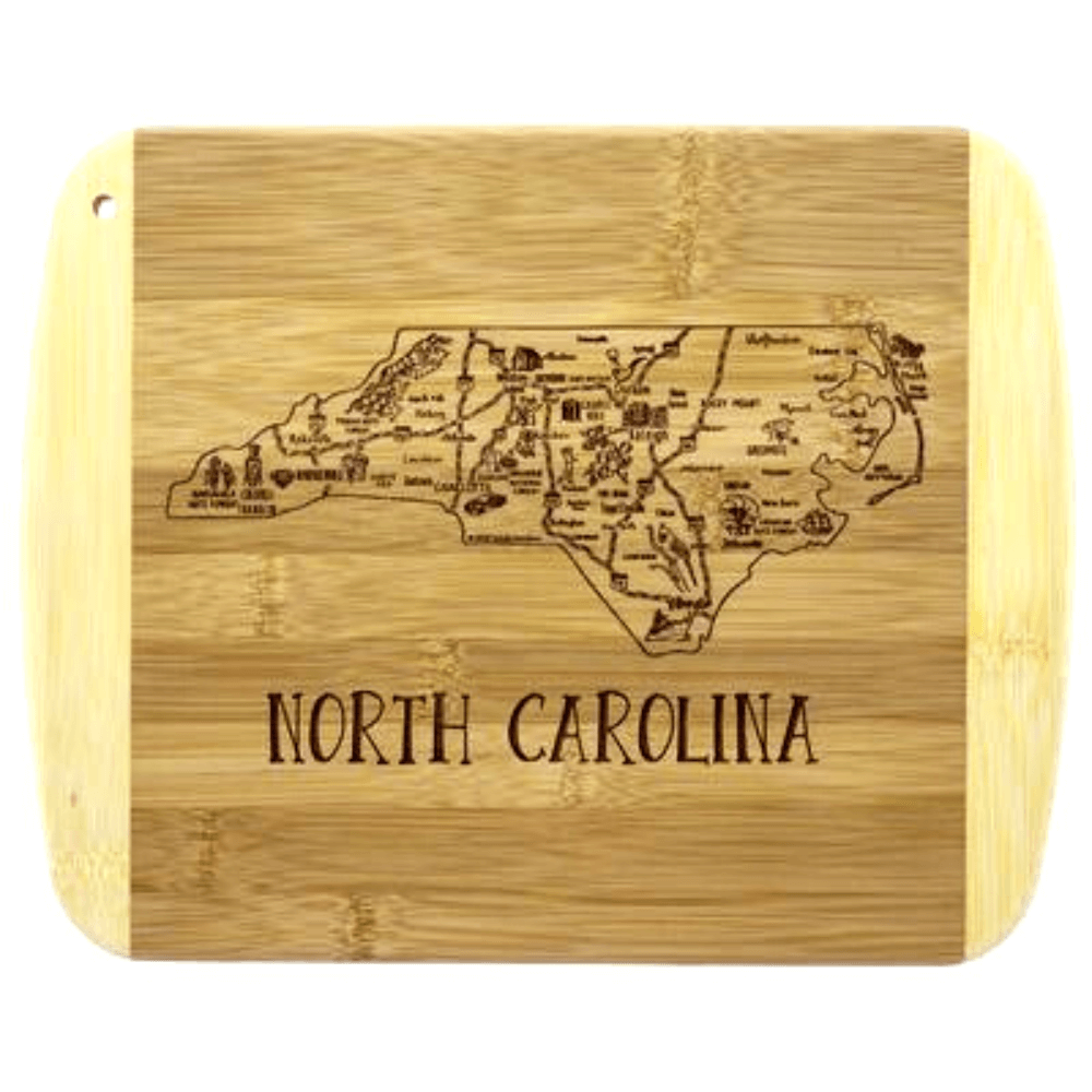 Rustic North Carolina-themed bamboo cutting board with engraved state map and text.