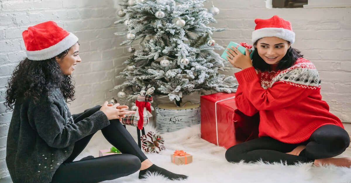 Two friends trying to figure out how to navigate Secret Santa, White Elephant, and other traditions