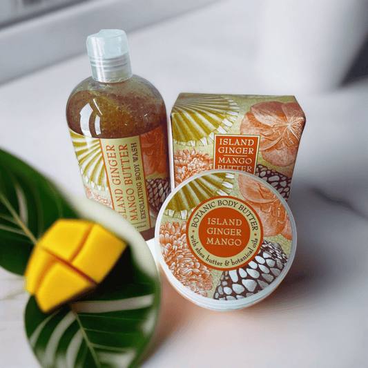 Island Ginger Mango bath and body collection featuring shea-mango butter products on a wooden surface.