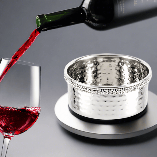 Elegant wine bottle coaster with hammered metal surface to catch drips and protect surfaces.