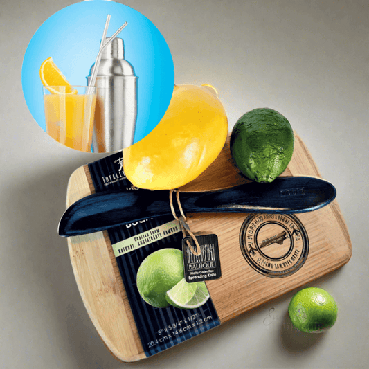 Compact bar set with wooden cutting board, cocktail shaker, and fresh citrus fruits.