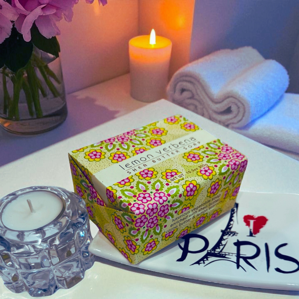 Box of Lemon Verbena soap with candles and flowers on a surface