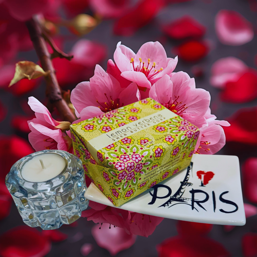 Decorative items including a candle, soap, and 'I love Paris' sign with cherry blossoms in the background.