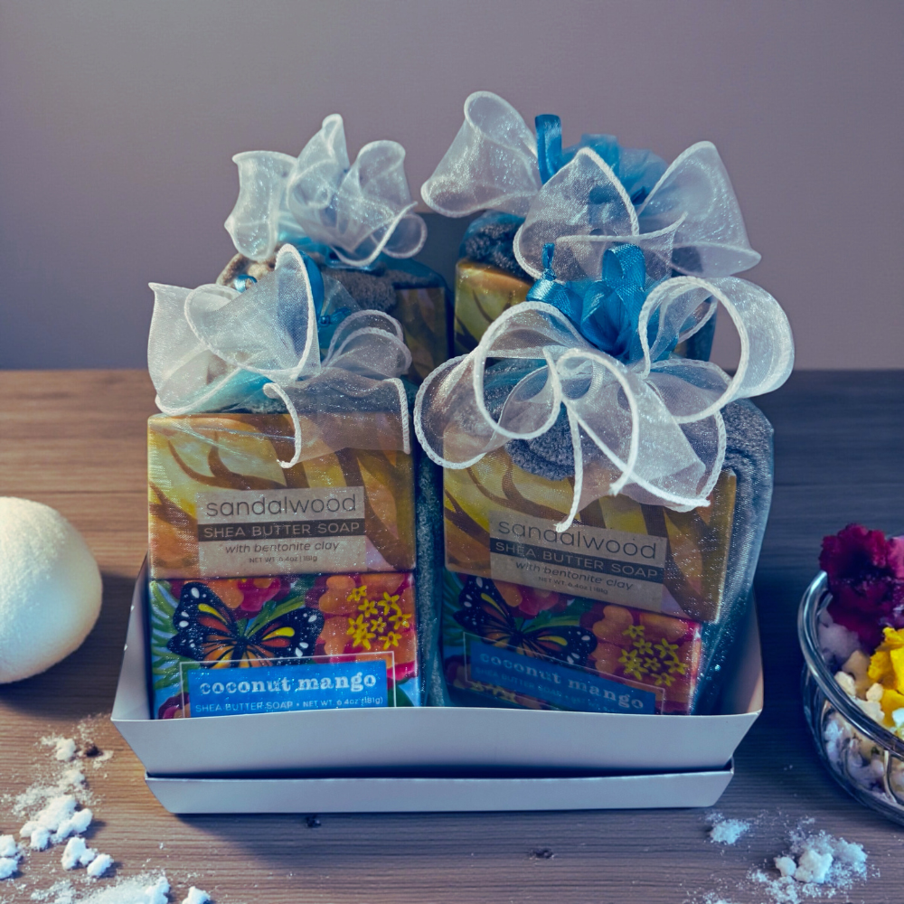 Gift set with soap bars in a decorative box on a wooden surface