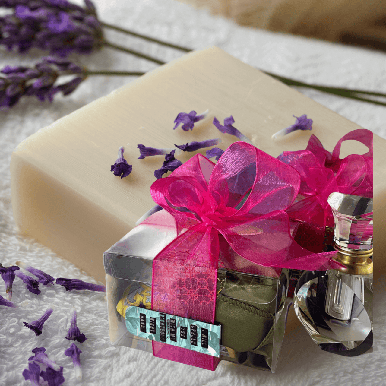 Artisan handcrafted bar soap with luxe wrapped gift box, lavender sprigs, and pink bow accents.