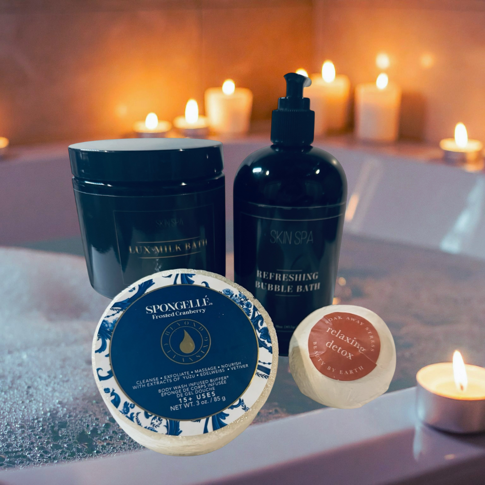 Bath products including a jar, bottle, and soap on a bathtub rim with candles in the background.