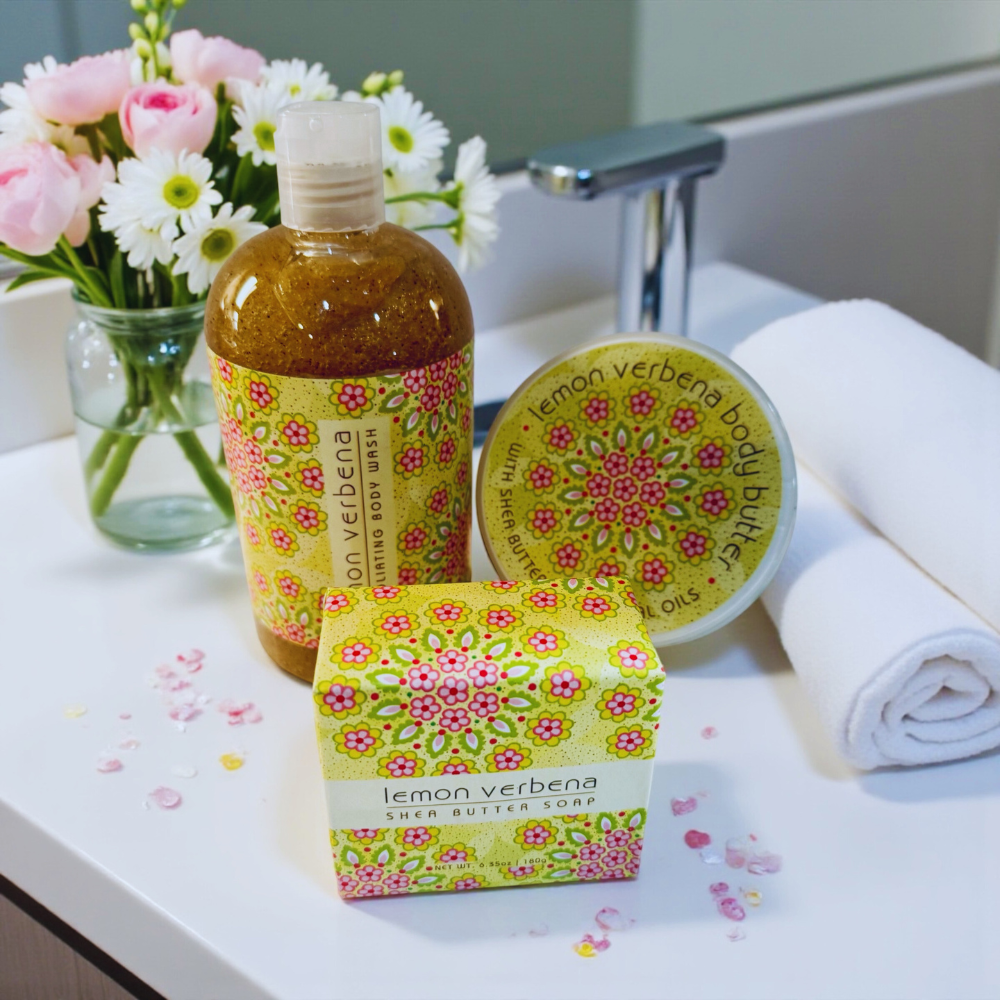 Lemon verbena body butter set with flowers and towel on a bathroom counter