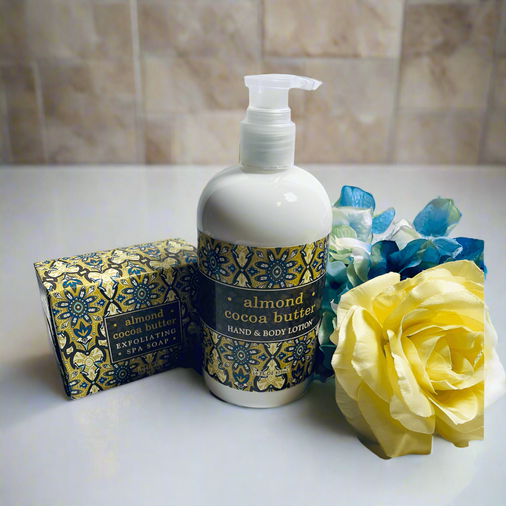 Lotion bottle with decorative label, soap bar, and yellow rose on a white surface with purple background