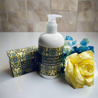 Thumbnail for Lotion bottle with decorative label, soap bar, and yellow rose on a white surface with purple background