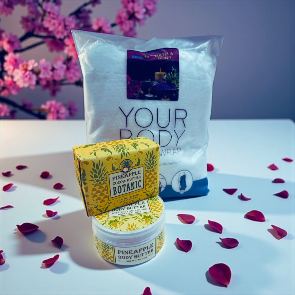 Pineapple body butter and packaging with cherry blossoms in the background