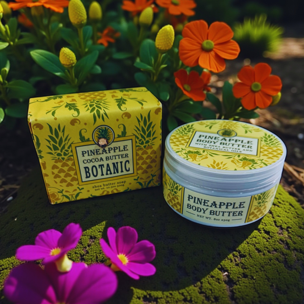 Pineapple body butter jar and box with flowers in the background