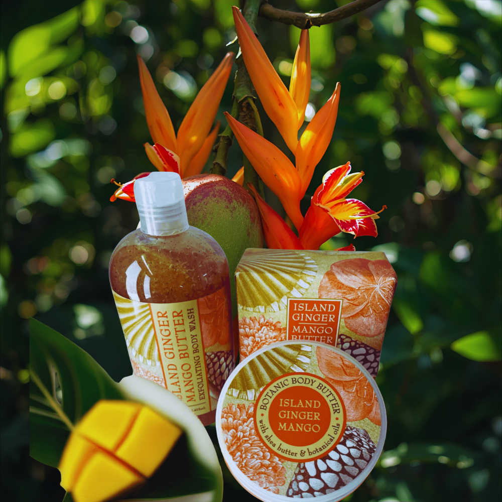 Island Ginger Mango body butter and soap with tropical flowers and leaves in the background