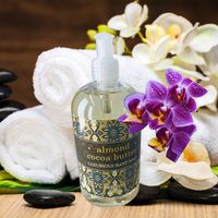 Thumbnail for Bottle of almond cocoa butter hand soap with flowers and towels on a wooden surface