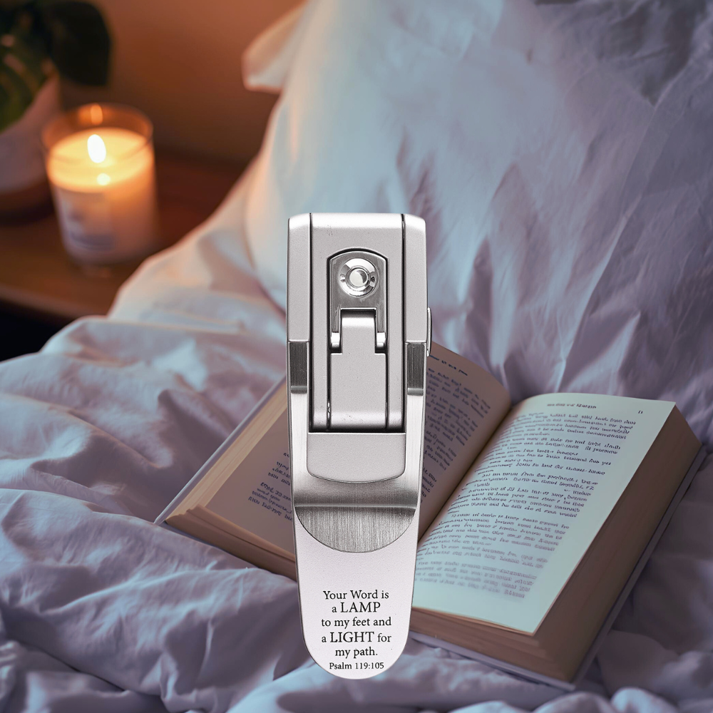 Lighting device on a book with a candle in the background