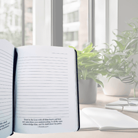 Thumbnail for Open book on a desk with a plant and window in the background