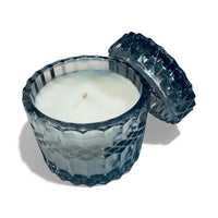 Thumbnail for Decorative candle in a textured gray holder on a white background