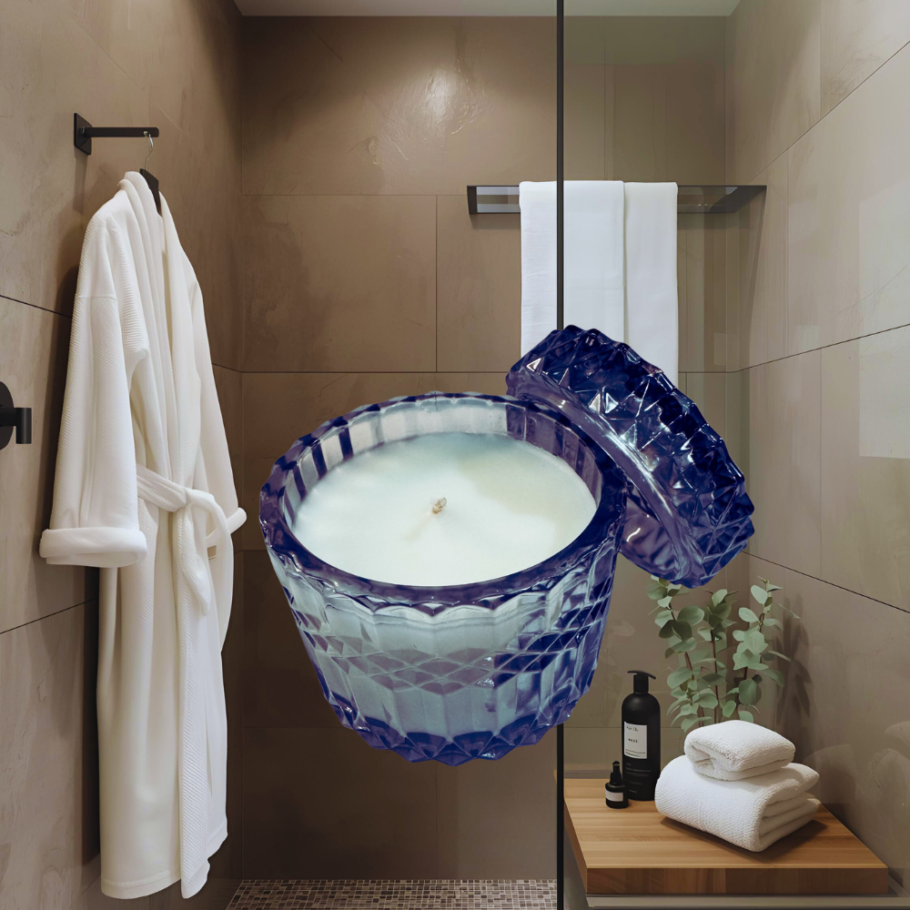 Bathroom setting with a large blue candle in the foreground