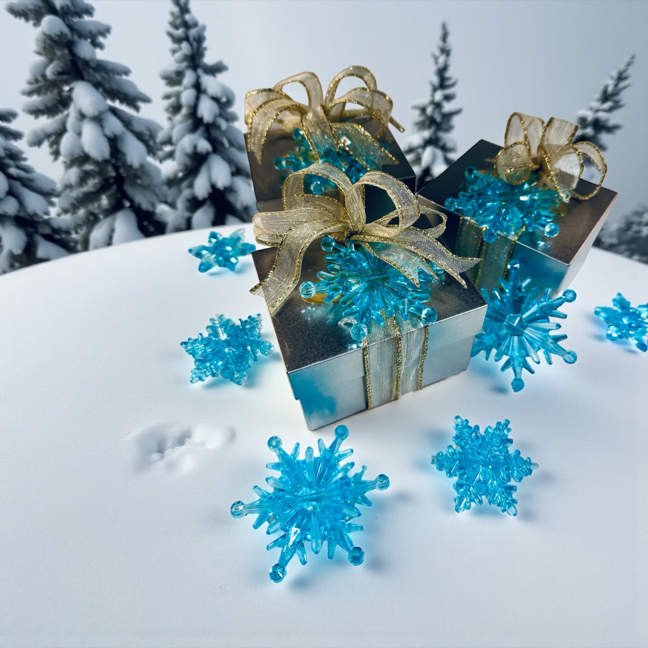 Decorative gift boxes with gold ribbons on a snowy background with blue snowflake decorations.