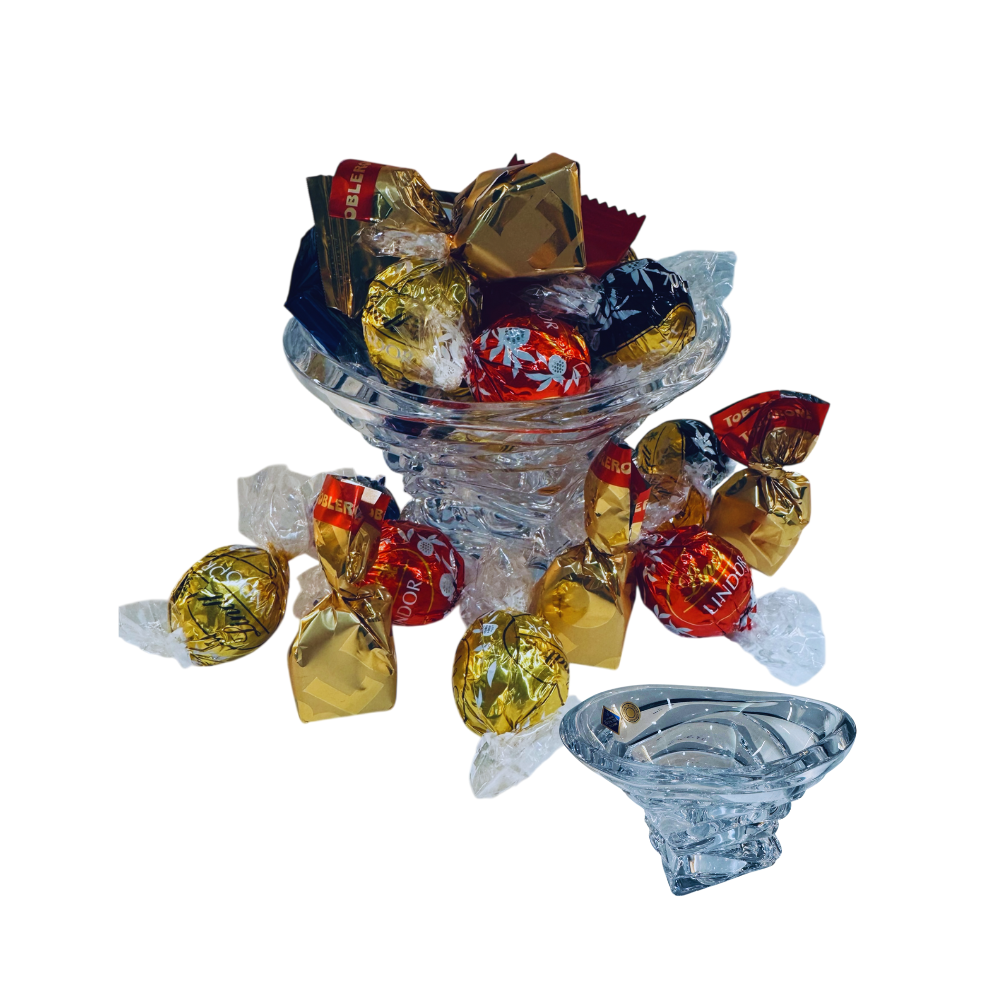 Clear glass bowl filled with colorful candies on a white background