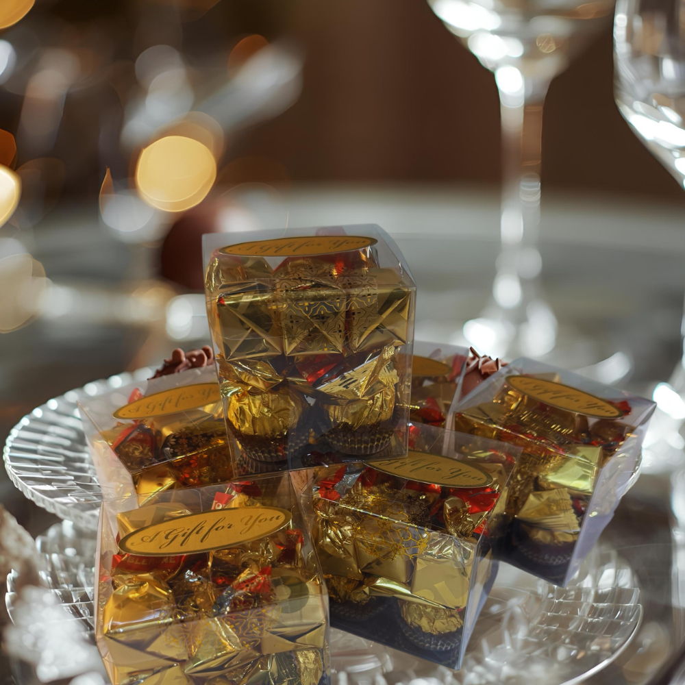 Gold-wrapped candies on a tray with blurred background
