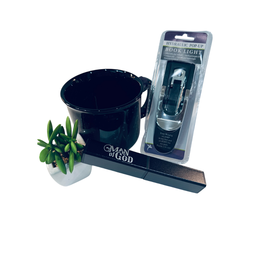 Black book light with packaging and a small plant on a white background