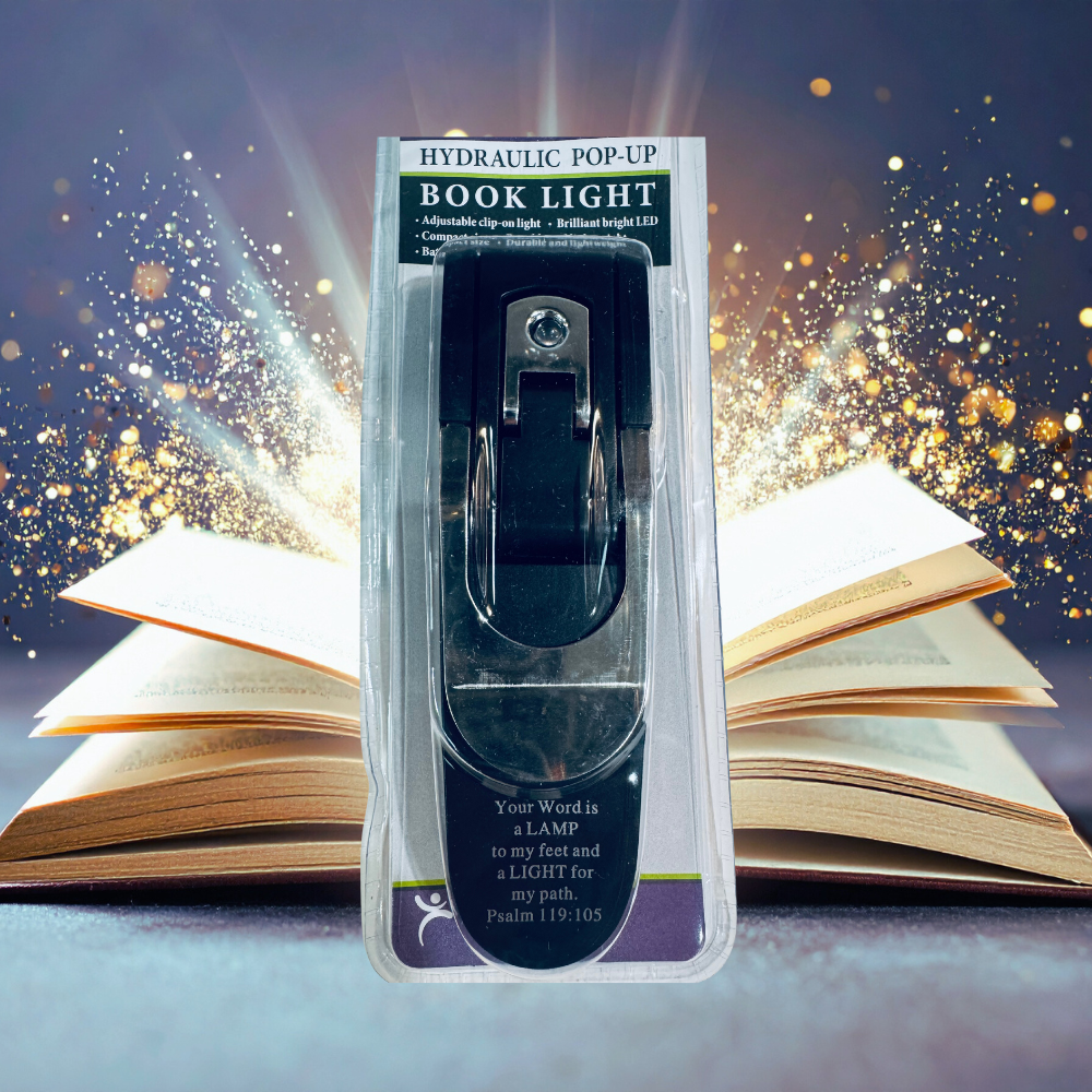 Hydraulic pop-up book light in packaging with open books in the background