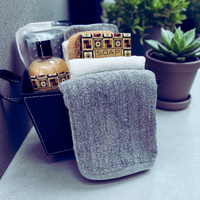 Thumbnail for Bathroom scene with soap, towel, and bottle on a counter with plants in the background