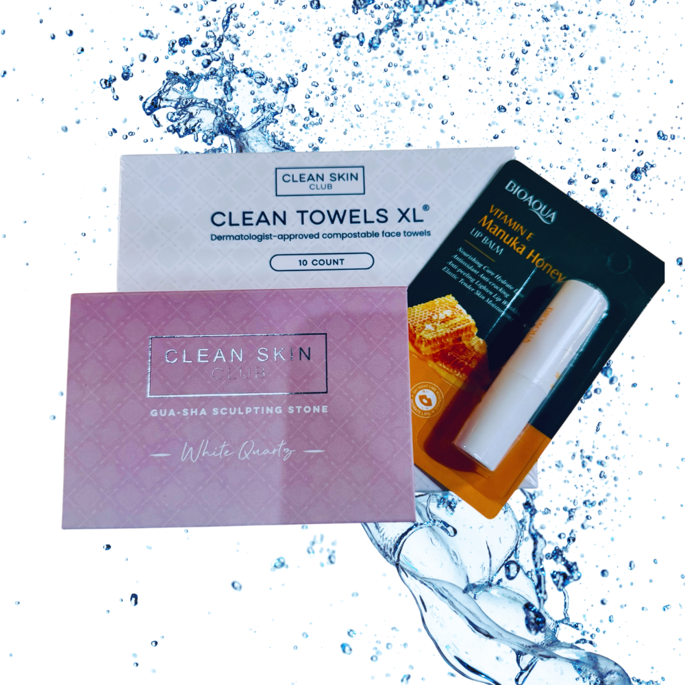 Collection of skincare products including towels and a stone on a water splash background