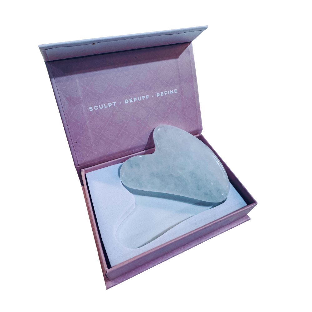 Gua Sha tool in an open purple box with text on a white background