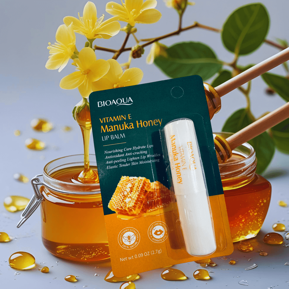 Bioaqua Vitamin E Manuka Honey lip balm with honey jar and flowers on a light background