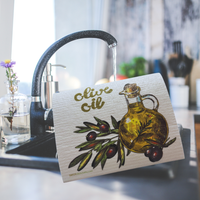 Thumbnail for A rectangular kitchen towel or mat with a printed illustration of an olive bottle, olives, and the words 'olive oil' in gold script, leaning near a running faucet in a kitchen setting.