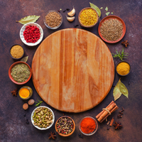 Thumbnail for Wooden cutting board surrounded by various spices and herbs on a dark surface