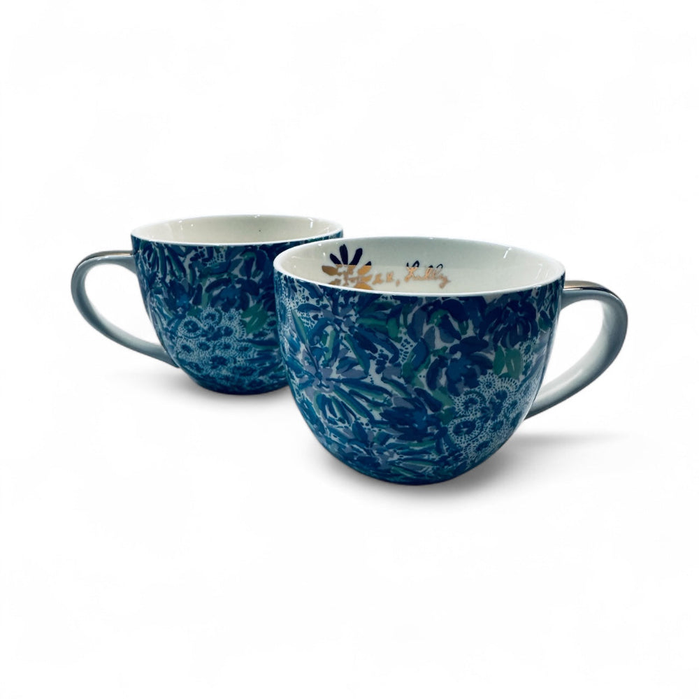 Two blue floral-patterned mugs on a white background