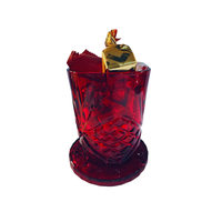 Thumbnail for Red glass with a gold leaf and red fruit on a white background