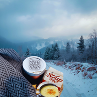 Thumbnail for Winter scene with soup mix and blanket against a snowy landscape