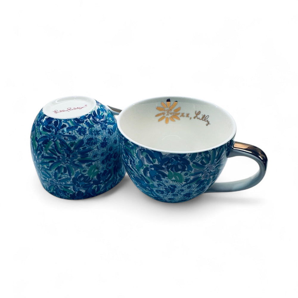 Blue floral-patterned mug and matching salt and pepper shaker set on a white background