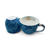 Thumbnail for Blue floral-patterned mug and matching salt and pepper shaker set on a white background