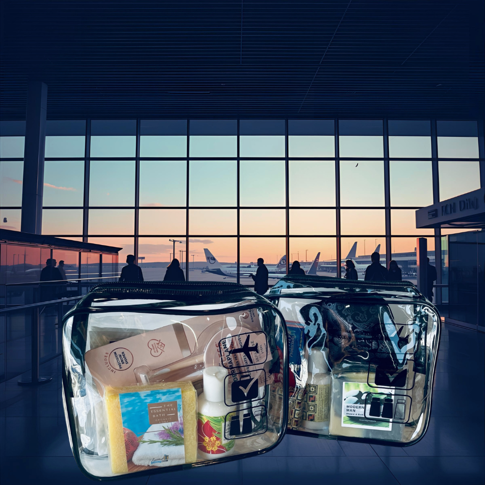 Clear travel bags with items at an airport terminal with planes outside.