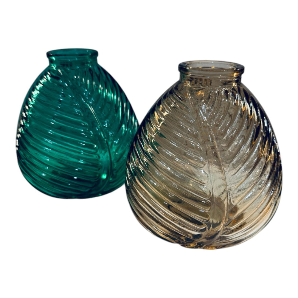 Two glass vases, one green and one clear, on a white background