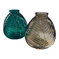Thumbnail for Two glass vases, one green and one clear, on a white background