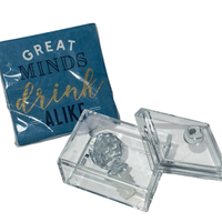 Thumbnail for Clear acrylic box with a silver object inside, next to a blue coaster with text.