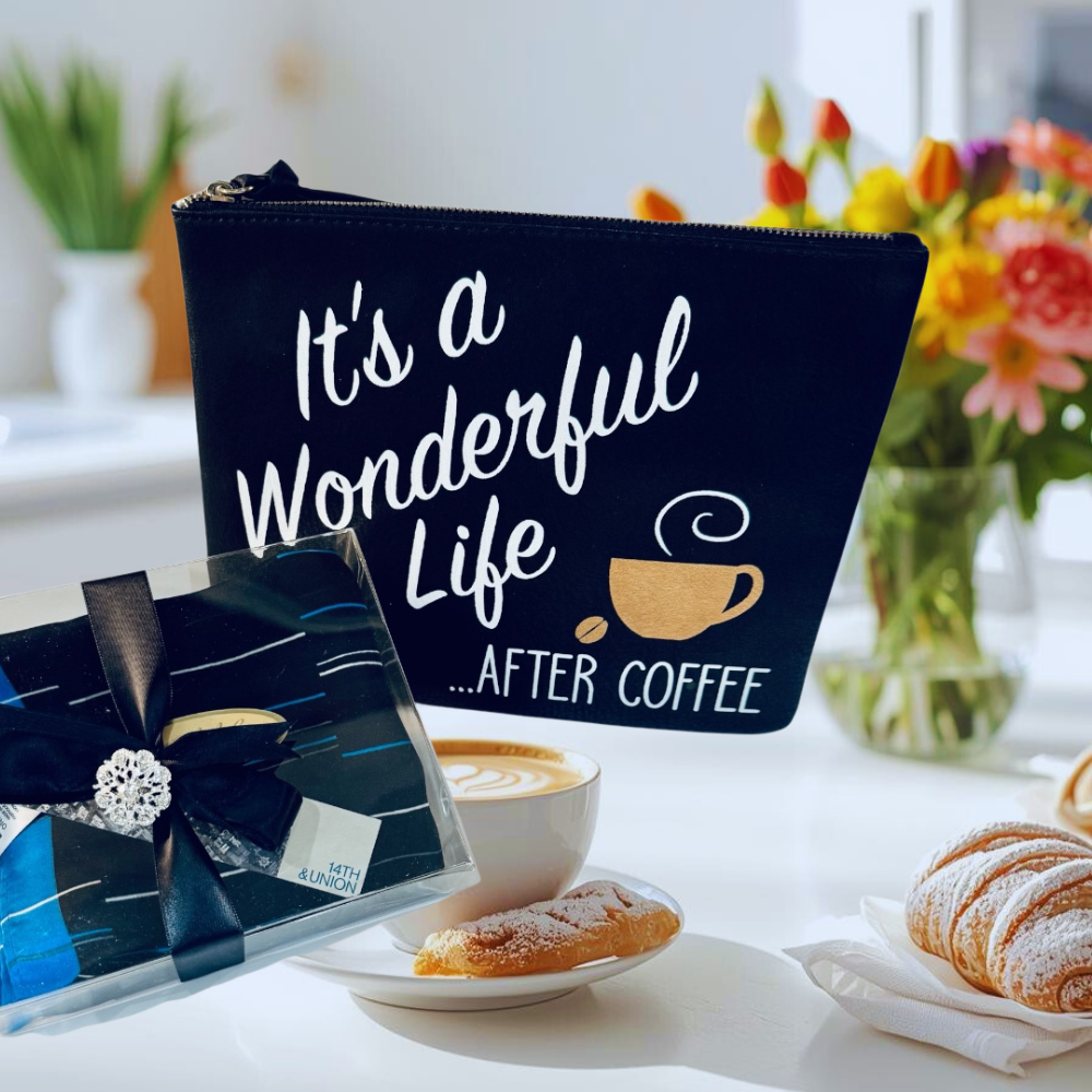 Black pouch with 'It's a Wonderful Life... After Coffee' text on a table with coffee and pastries.