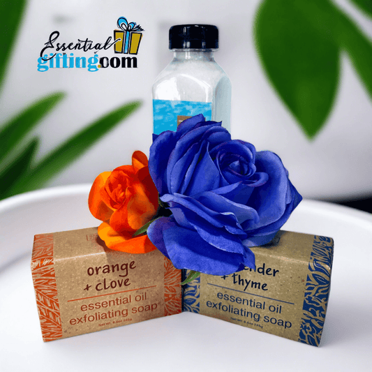 Bar Soap Exfoliating Bath Gift Set featuring colorful bath products including orange and blue rose flowers, essential oil soaps, and a bottle of essential oil.