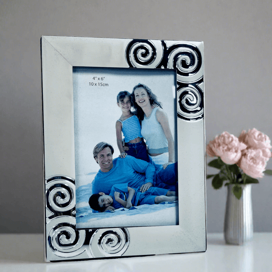 Silver-toned photo frame with decorative swirl patterns, suitable for a 4x6 inch portrait photo.