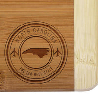 Thumbnail for Rustic North Carolina Souvenir Mini Bar Board Set - Wooden cutting board with engraved North Carolina state shape and motto.