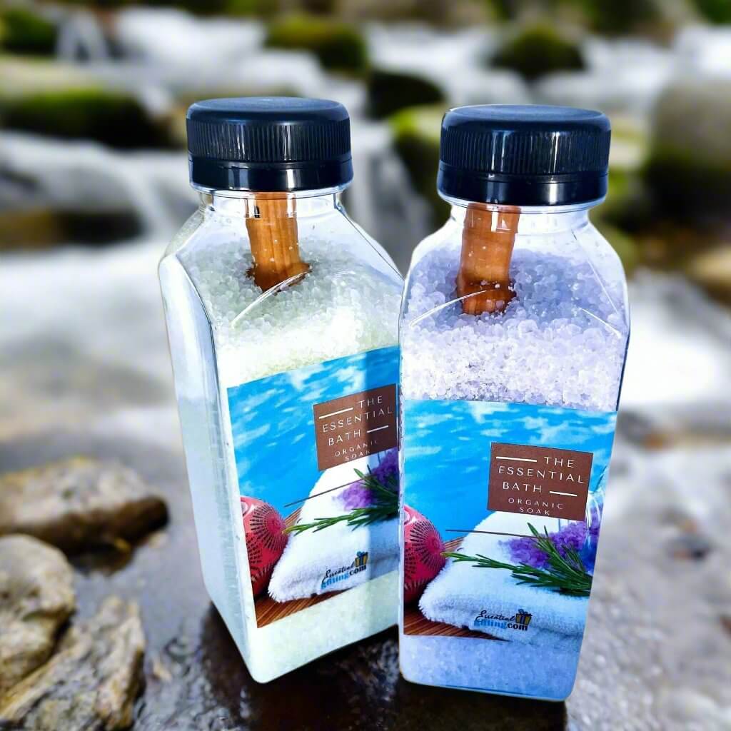 Artisan bath salts in glass bottles with coastal scenery and lavender accents on white background.