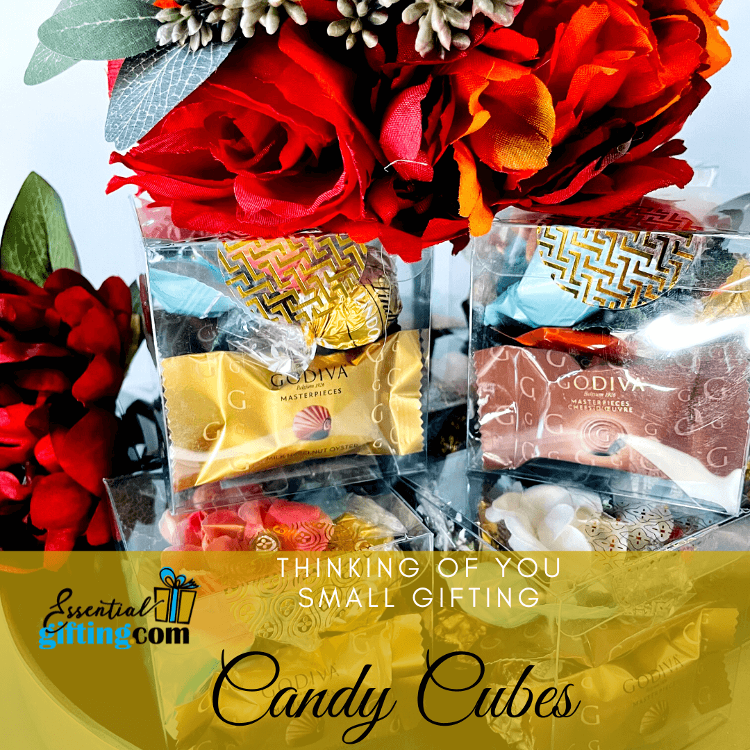 Colorful candy cubes in a festive gift box with red roses and decorative elements, offering a thoughtful small gifting option.