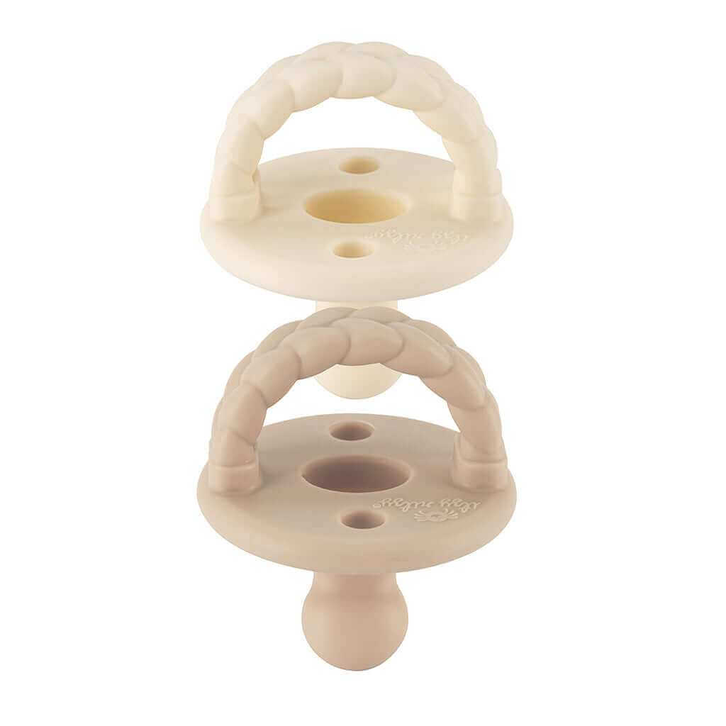 Pacifier set featuring a stroller caddy in neutral tones, designed for convenient baby care on the go.